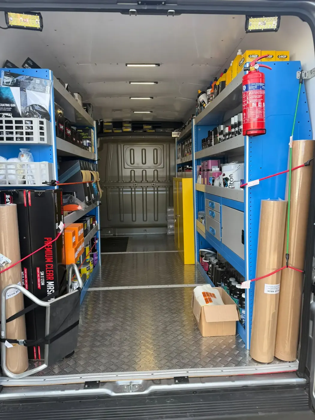 Full-length van interior with shelving systems on both sides